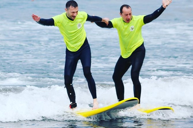 Surf Class Experience in Playa de la Américas - Taking the board into the ocean