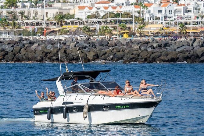 Tenerife Motor Boat Whale Watching & Snorkeling Experience - A small boat with two very different seating areas